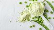 A plastic scoop filled with plant-based pea protein powder, accompanied by fresh green pea seeds, all against a white background. An isolated copy space for additional text or design elements