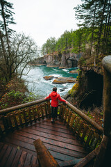 USA, Washington State. Woman on observation deck at Cape Flattery, the most northwesterly tip of the contiguous USA, at terminus of the Makah tribe trail.