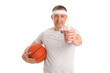 © Pixel-Shot - Sporty mature man with glass of fruit smoothie and ball on white background
