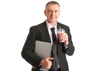 Wall Mural - Mature businessman with glass of fruit smoothie and laptop on white background