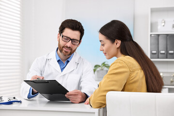 Sticker - Doctor consulting patient during appointment in clinic