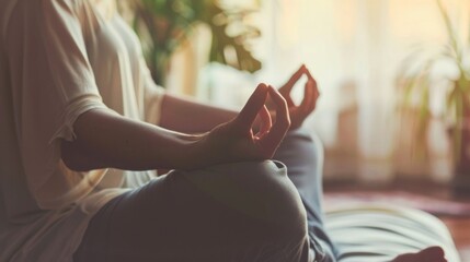 A person sits with their legs crossed and one arm dd over the back of the chair projecting an aura of ease and contentment. .