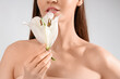 © Pixel-Shot - Beautiful young woman in underwear with white lily flower on grey background, closeup