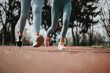 © qunica.com - A dynamic low-angle shot capturing the feet of joggers in action on a park trail, highlighting an active lifestyle.