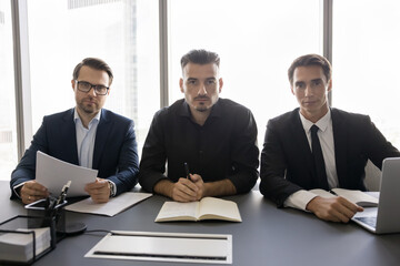 Sticker - Portrait of three young 35s HR managers interviewing applicants seated at desk in modern conference room, looking at camera engaged in video call with corporate partners, take part in online teamwork