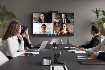Wall Mural - Four applicants on monitor screen, HR managers listen candidates at remote job interview, virtual meeting. Video call application usage for negotiations and business communication. Telemeeting event