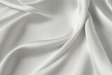 Fototapeta  - luxury cloth with drapery and wavy folds of ivory color creased smooth silk satin material texture.