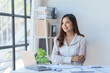 © amnaj - Beautiful and confident Asian businesswoman arms crossed thinking new idea at office.