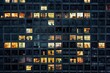 A high-rise building with rows of windows at night, each window lit up in the style of office workers working late into the evening. For Business, News, Labor Day