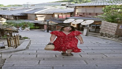 Sticker - Confident and joyful, beautiful hispanic woman posing and walking with a positive smile towards the camera, lighting up the ancient streets of gion, kyoto