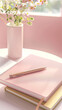 © Cavan - A pink notebook , placed beside a pen and some books in a table