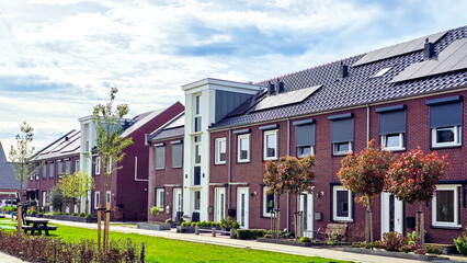 Poster - Newly built houses with black solar panels on the roof against a sunny sky, Zonnepanelen, Zonne energie, Translation: Solar panel, Sun Energy