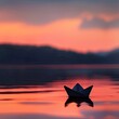 Paper boat on a smooth lake at sunset