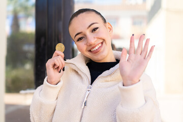 Canvas Print - Young moroccan girl  at outdoors saluting with hand with happy expression