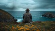 Old man sitting alone, gazing over the turbulent sea from a cliff, surrounded by wildflowers under a stormy sky.