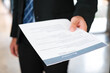 Close-Up of Businessman Holding a Resume.