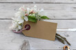 Apple blossom branches and card with copy space on a wooden background