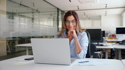 Wall Mural - Happy busy mature business woman employee in office using laptop at work, smiling professional middle aged female company manager working looking at computer at workplace.