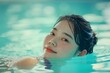 Determined Asian woman swimming indoor pool closeup photo. Female swimmer with face above the water. Generate ai