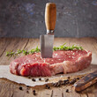 Fresh steak on cutting board with knife