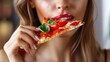Young Caucasian suntanned beautiful elegant woman eating, biting Italian thick tomato pizza with burata cheese Yummy unhealthy food.