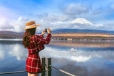 Fototapeta Miasta - Tourist taking photo at Yamanakako lake, Japan.