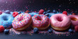 Assorted doughnuts topped with sprinkles and blueberries on a table banner
