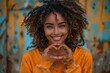 young african - american woman standing and making heart shape with hands in park.