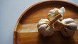 Isolated garlic or Allium sativum on a wooden tray. Selective focus                             