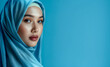 © VISUAL BACKGROUND - A beautiful woman in blue hijab.