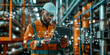 © PHILL THORNTON PHOTO - Engineer with laptop inspects industrial equipment, shallow depth of field, with technical drawings and holographic images projected in background.