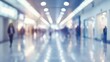 © Johannes - Blurred defocused bokeh background of exhibition hall or convention center hallway. Business trade show modern white interior architecture. Abstract blur modern business office backgroun