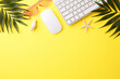 Top view of a tropical summer workspace with palm leaves on a bright yellow background
