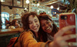 ©  J. GALIÑANES STOCK - Interracial group of friends taking a selfie in a cafe, pub or restaurant. Friends chatting, joking and enjoying their friendship. Relationships between friends, meeting to hang out, meeting to have f