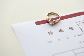 Japanese marriage registration blank document and wedding proposition ring on table close up