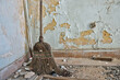vintage straw broom on dusty abandoned house floor