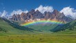   A rainbow spans the middle of a mountain range; clouds populate the sky above