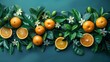   A collection of oranges atop green leaves, adorned with white-blooming flowers