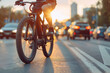 Close-up of a cyclist on a mountain bike commuting in early morning traffic, with the sunrise creating a silhouette effect
