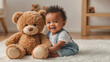 cute little African American baby with teddy bear at home play
