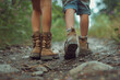 A cute sister and brother's feet hiking on a scenic trail, exploring the wonders of nature.