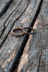 Sticker - Two wedding rings displayed on a rustic wooden table. Perfect for wedding themes and jewelry concepts