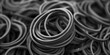 A pile of black and white rubber bands, useful for various office and household purposes