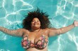 A woman with a large bust is floating in a pool