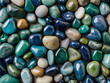 Trendy blue and green small sea stone pebble background. Colorful gemstones crystal pebbles on beach. Multicolored abstract beach nature pattern
