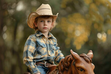 A Boy In A Cowboy Hat Riding A Rocking Horse.
