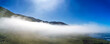 Panorama view of mountains in clouds, fog