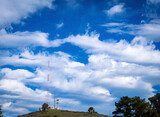 Fototapeta Kwiaty - Clouds over antennas on hill, towers