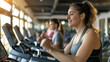 © vrozhko - young smiling woman exercising on treadmill in gym with friends, modern fitness center on background