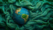 earth globe on green crinkled fabrics, global warming concept